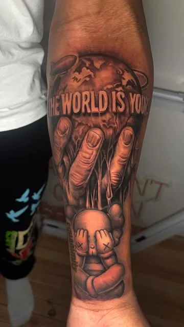 A black and grey sleeve of hands over a face.