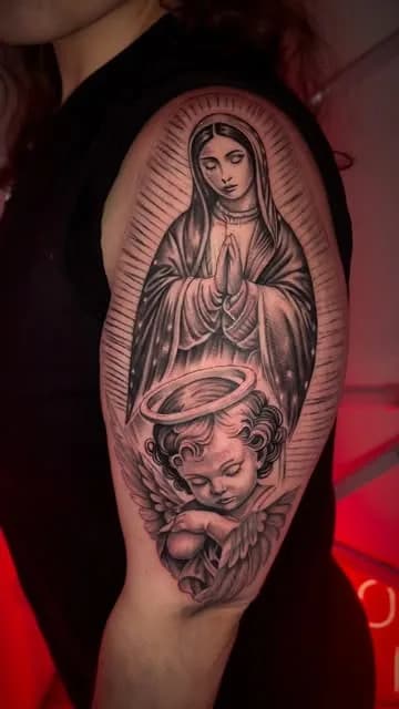 A black and grey Madonna and cherub piece.