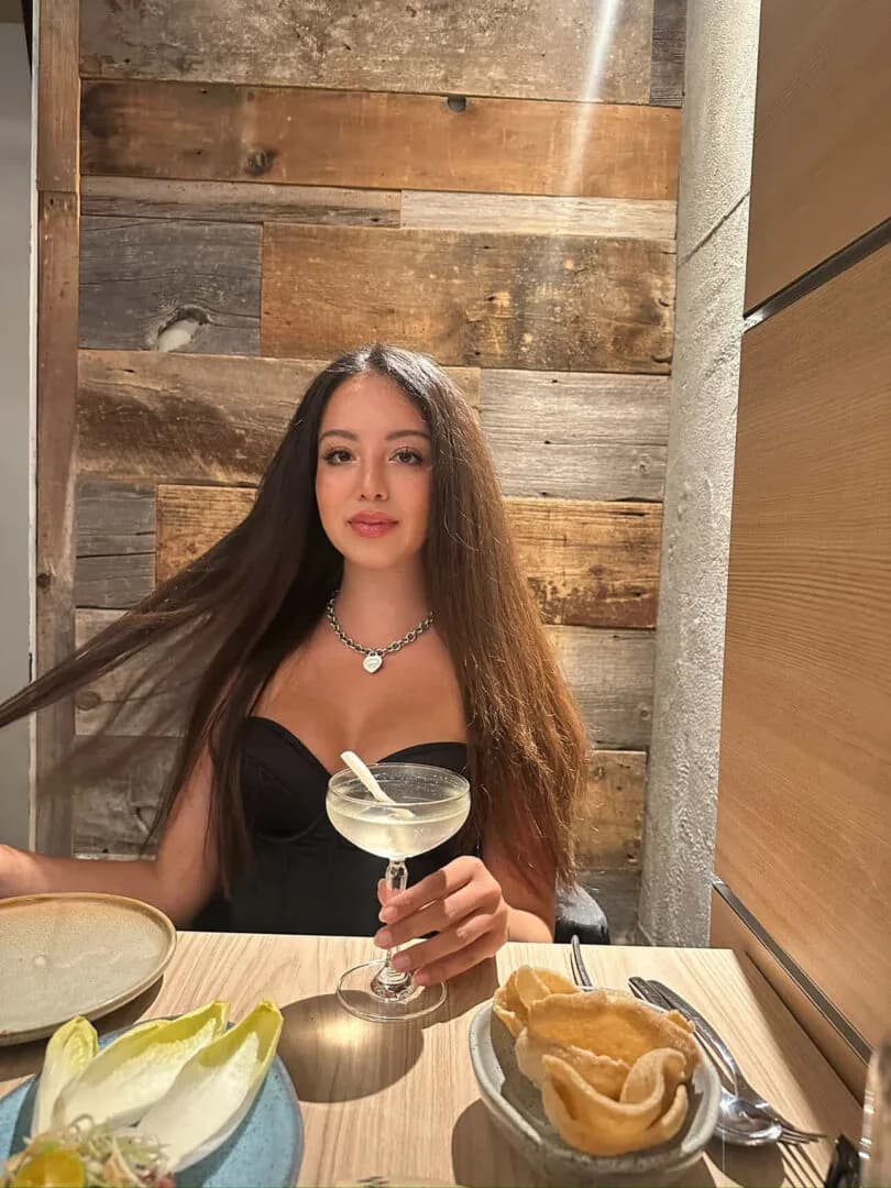 Jessica at dinner with a cocktail.