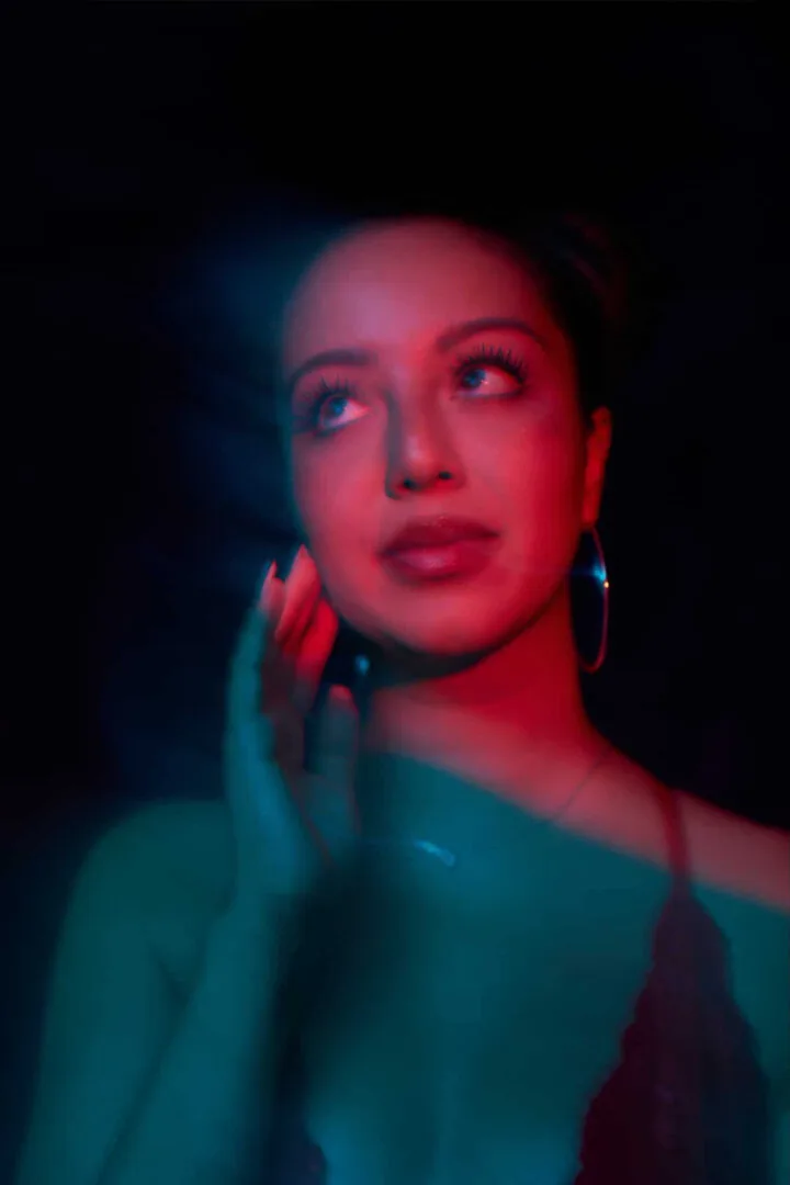 Jessica Chin King in teal and red light.